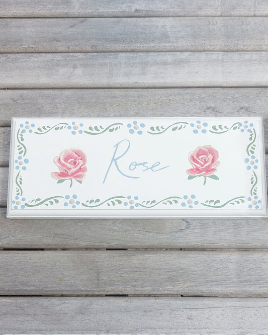 Nursery door sign personalised with the name 'Rose', featuring beautiful roses and a decorative blue floral border, perfect for baby room decor.