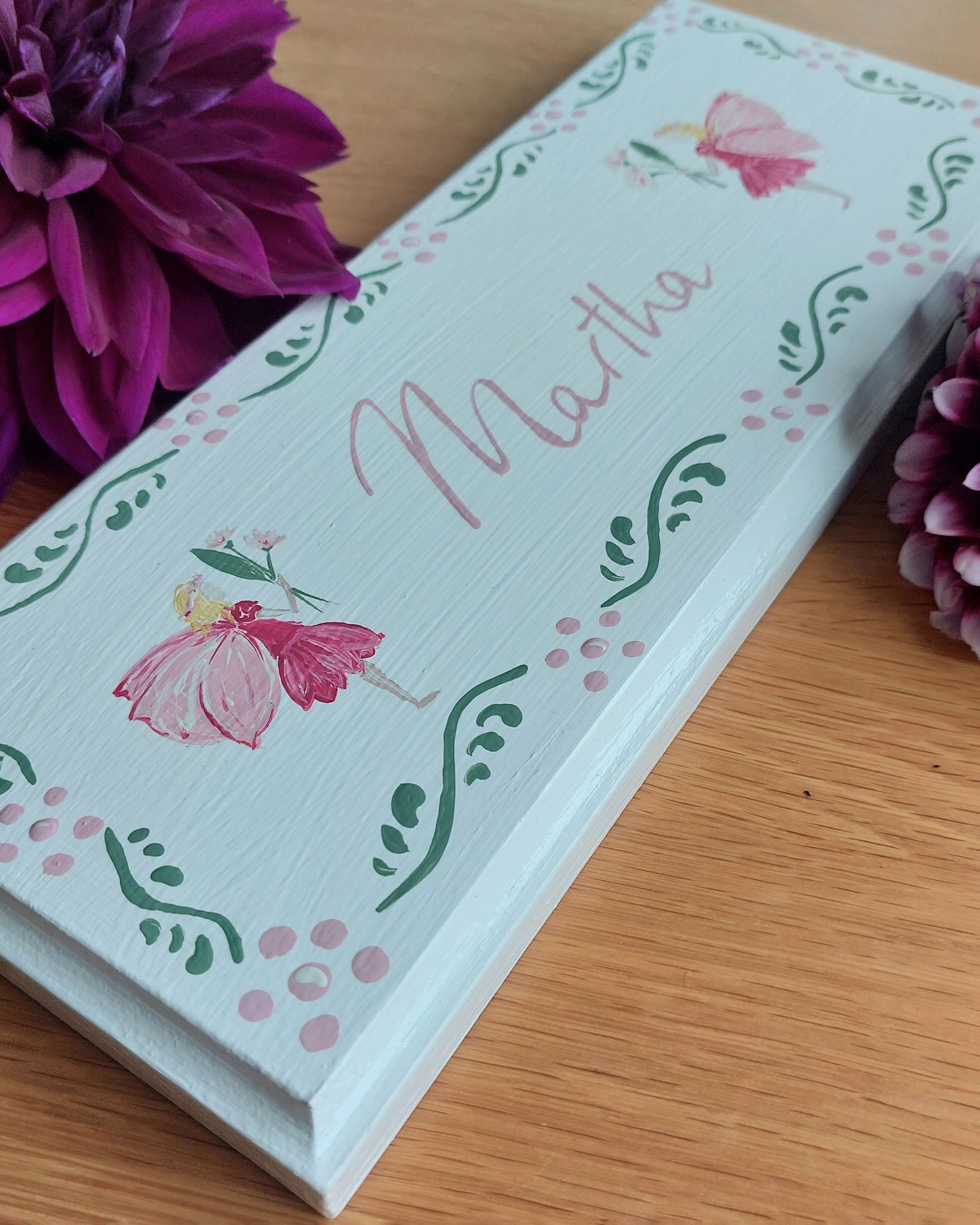 Nursery door sign personalised with the name 'Martha', featuring magical fairies and a decorative pink floral border, perfect for baby room decor.