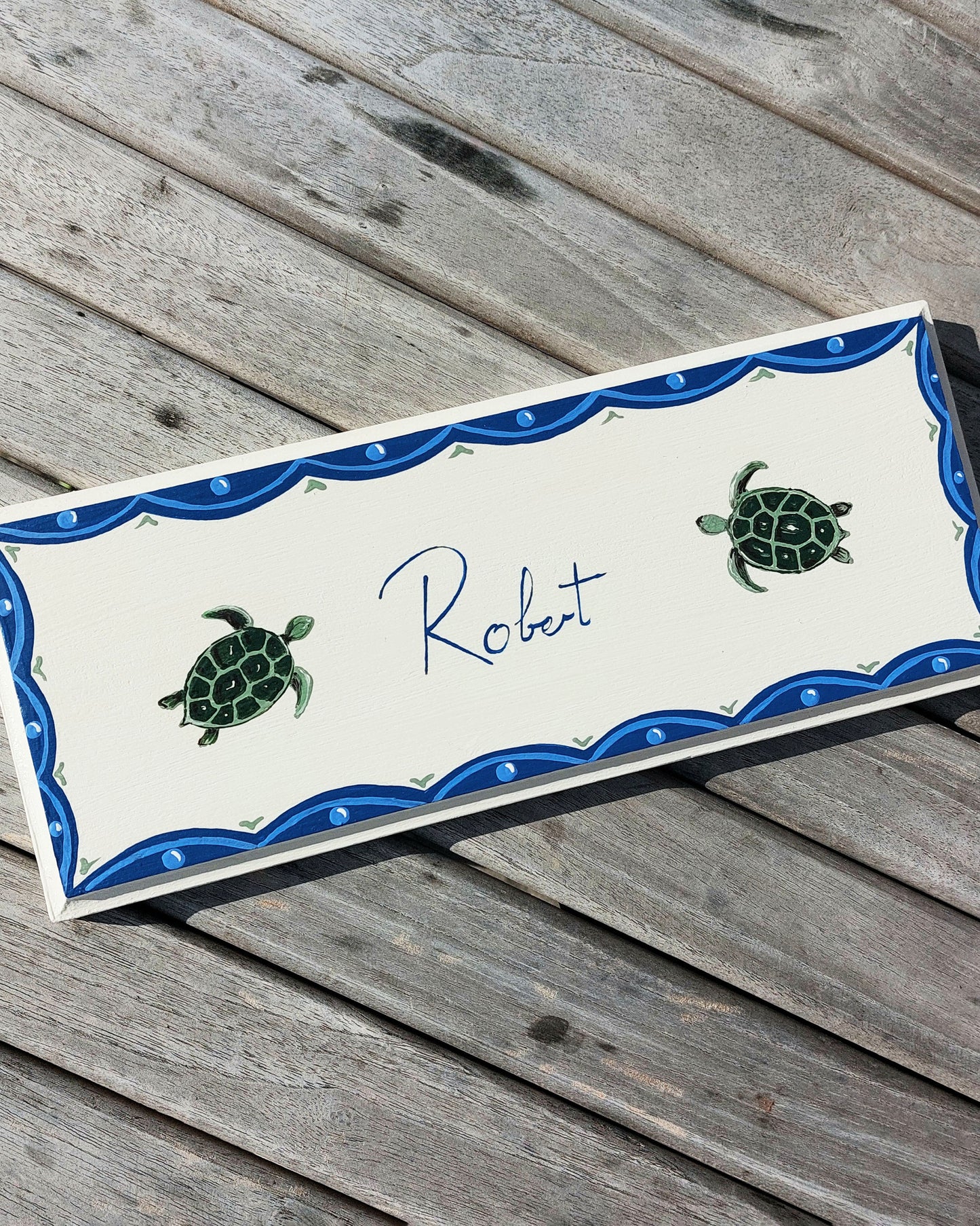 Nursery door sign personalised with the name 'Robert', featuring adorable sea turtles and a decorative blue scalloped border, perfect for baby room decor.