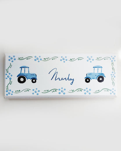 Nursery door sign personalised with the name 'Marley', featuring farmyard tractors and a decorative blue floral border, perfect for baby room decor.