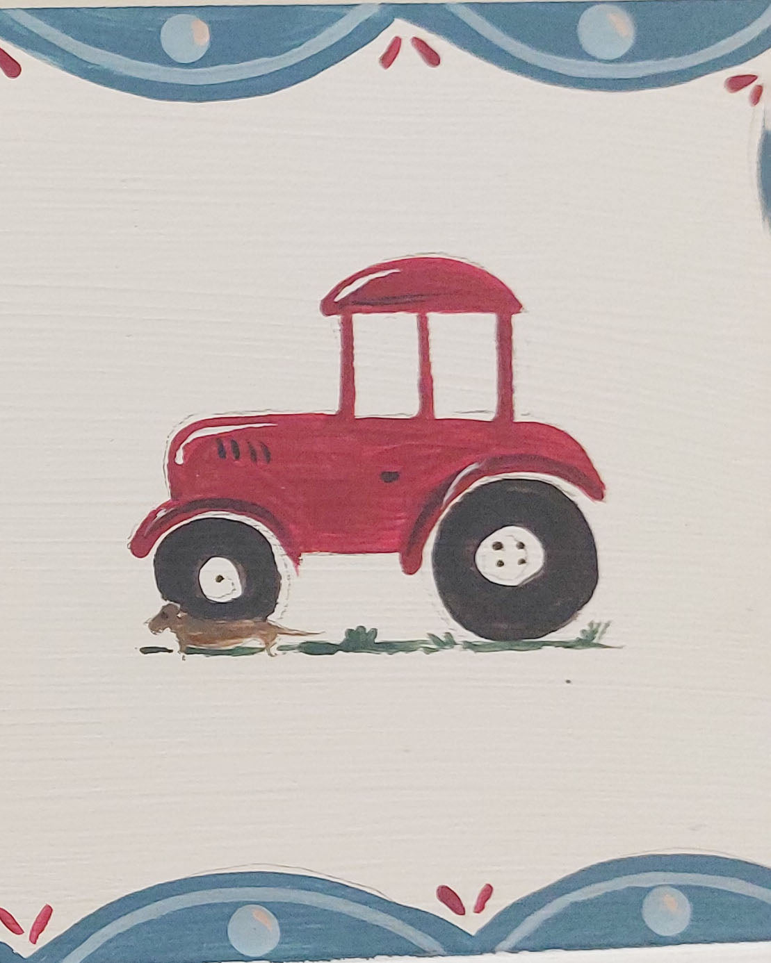 Close up a a nursery door sign personalised, featuring farmyard tractors and a decorative blue scalloped border, perfect for baby room decor.