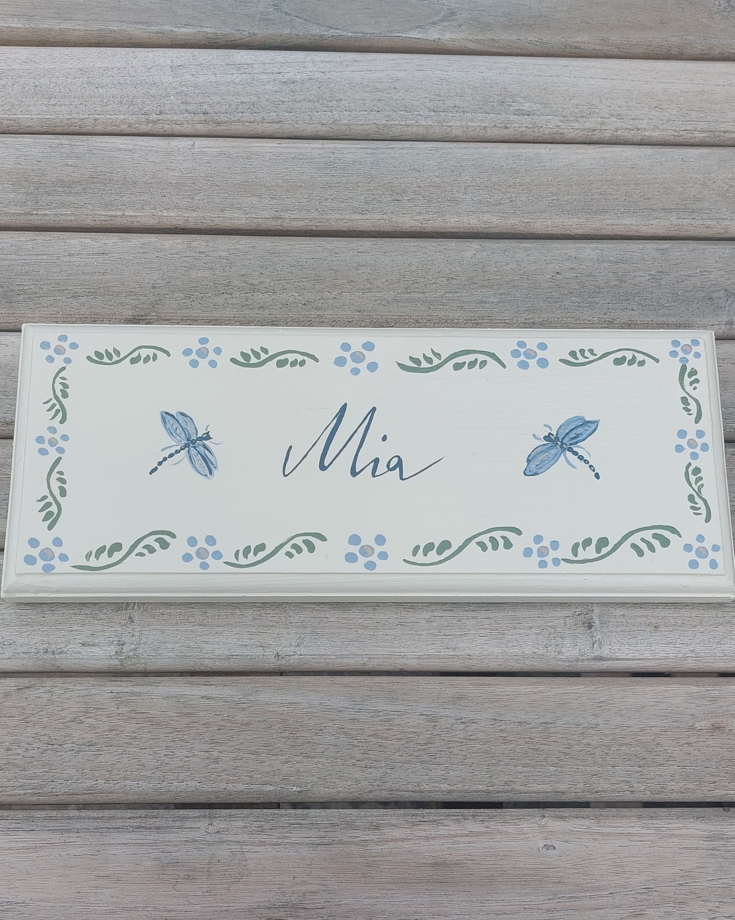 Nursery door sign personalised with the name 'Mia', featuring magical dragonflies and a decorative blue floral border, perfect for baby room decor.