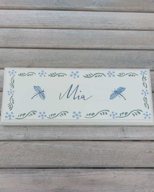 Nursery door sign personalised with the name 'Mia', featuring magical dragonflies and a decorative blue floral border, perfect for baby room decor.