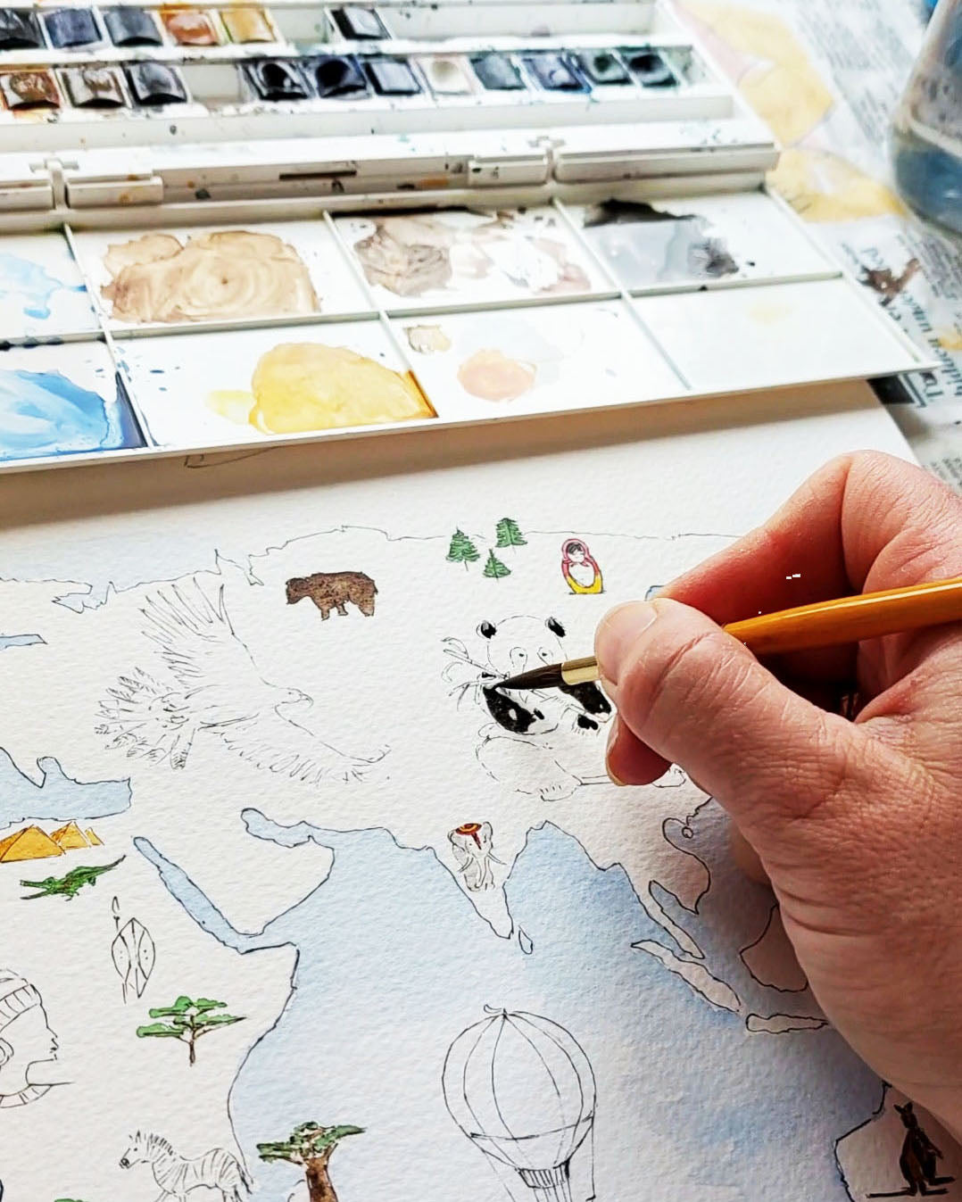 Personalised world map print with wildlife illustrations, educational nursery wall art.