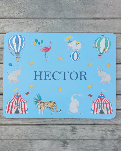 Hand-painted watercolour melamine placemat featuring various circus animals and tents, cork-backed and heat-resistant, ideal for kids' meals, made in the UK.