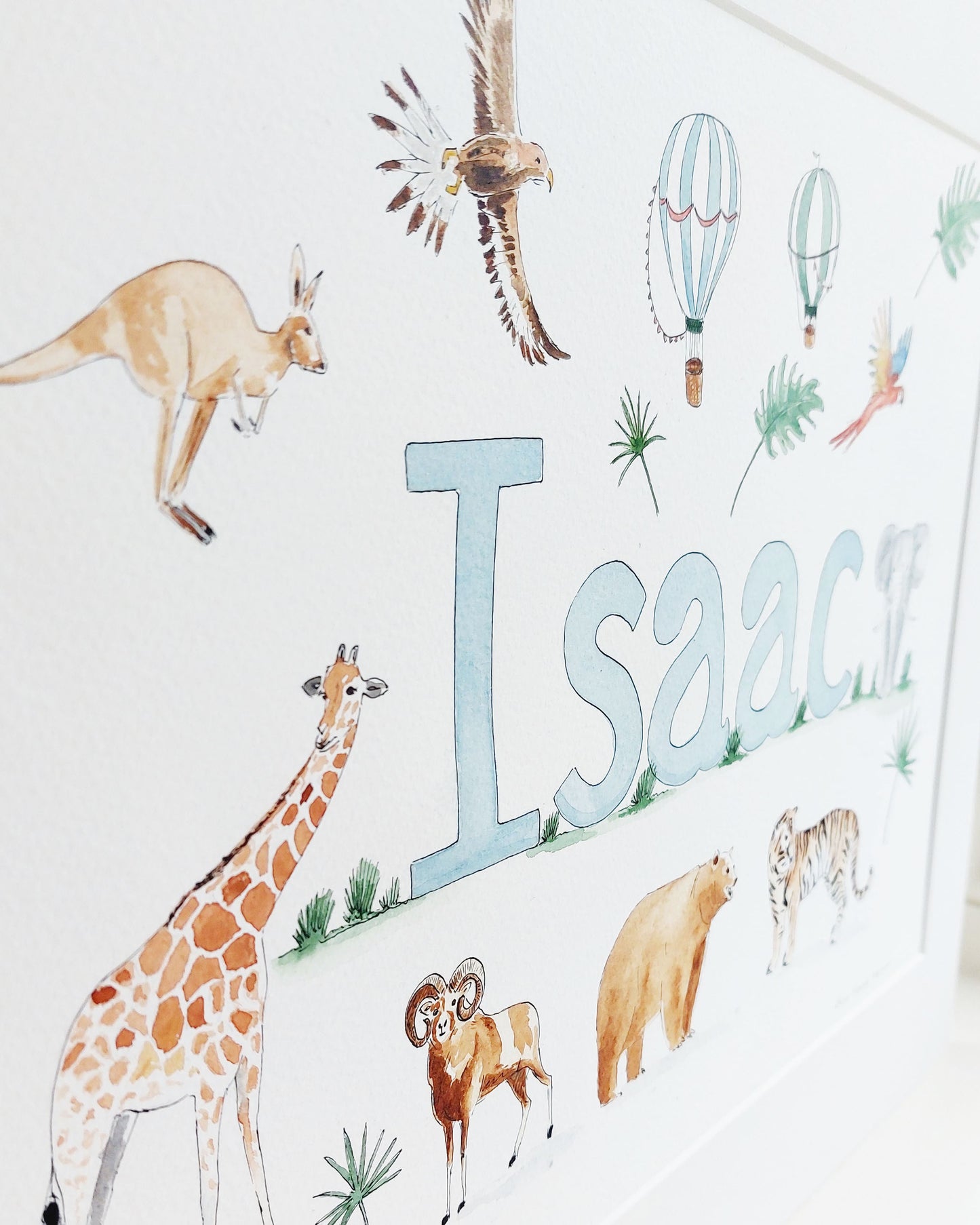 Hand-painted watercolour name painting for nursery decor, featuring the name 'Isaac', personalised with a safari theme, perfect for children's room wall art.