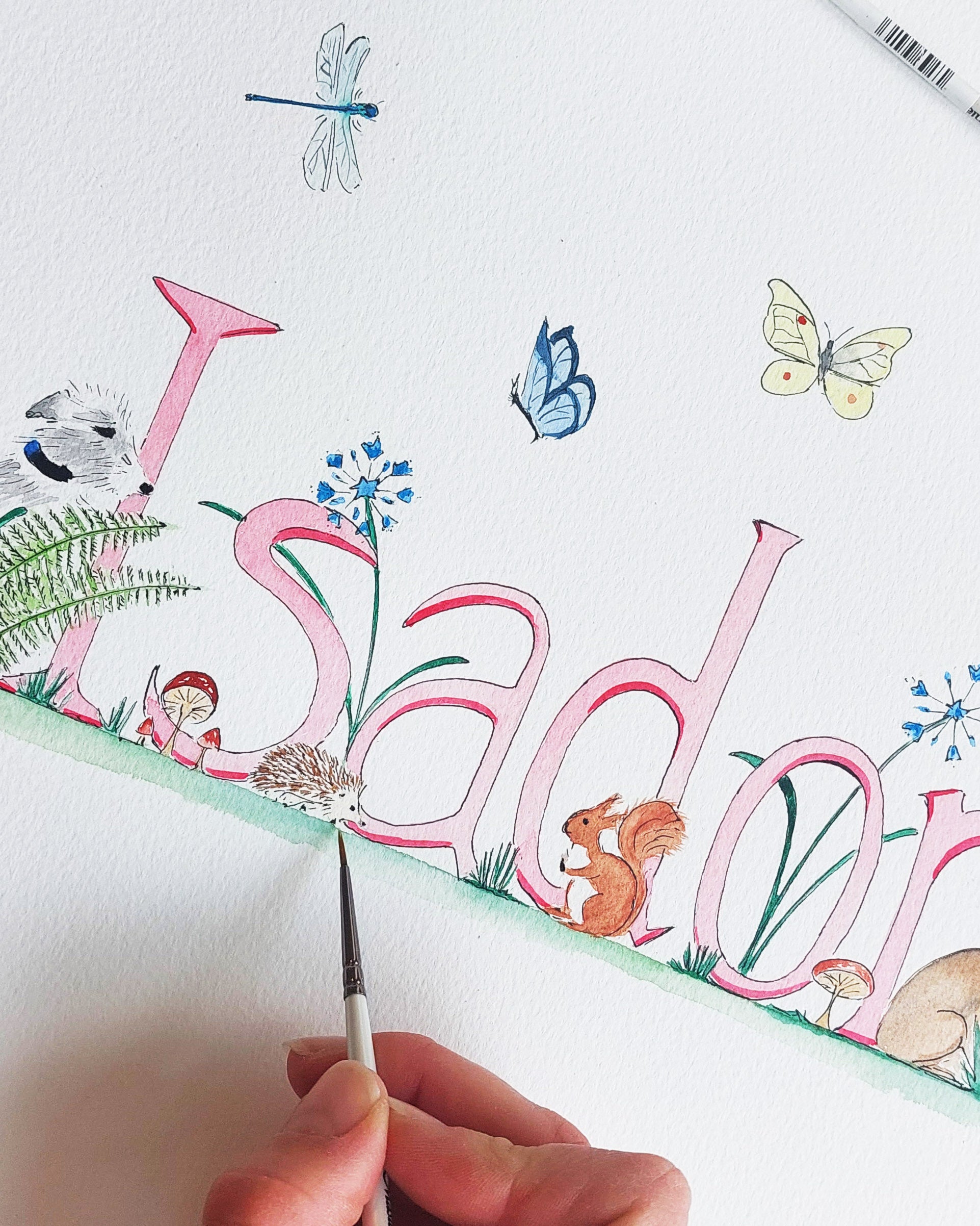 A hand-painted watercolour featuring woodland creatures and the name 'Isadora'